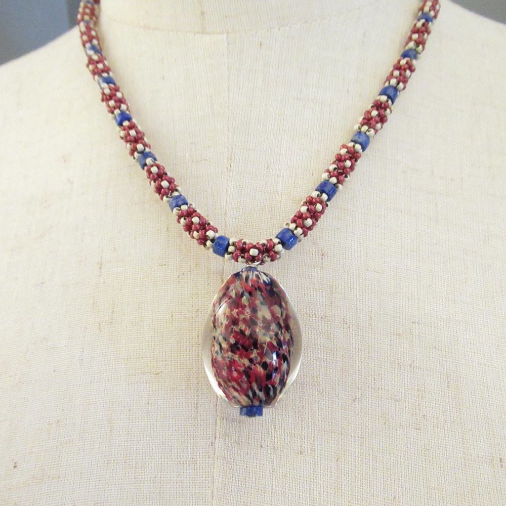 Blown glass pendant necklace with handweaving and Lapis